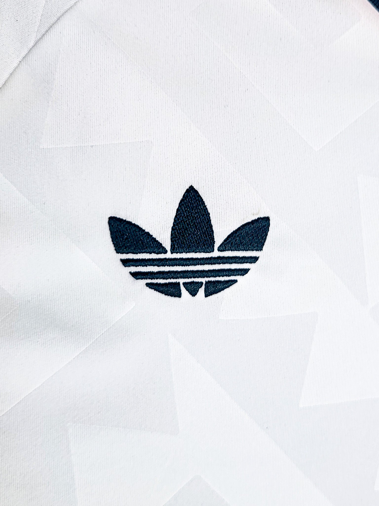 Close-up of the Mexico 2026 Adidas logo on a white background