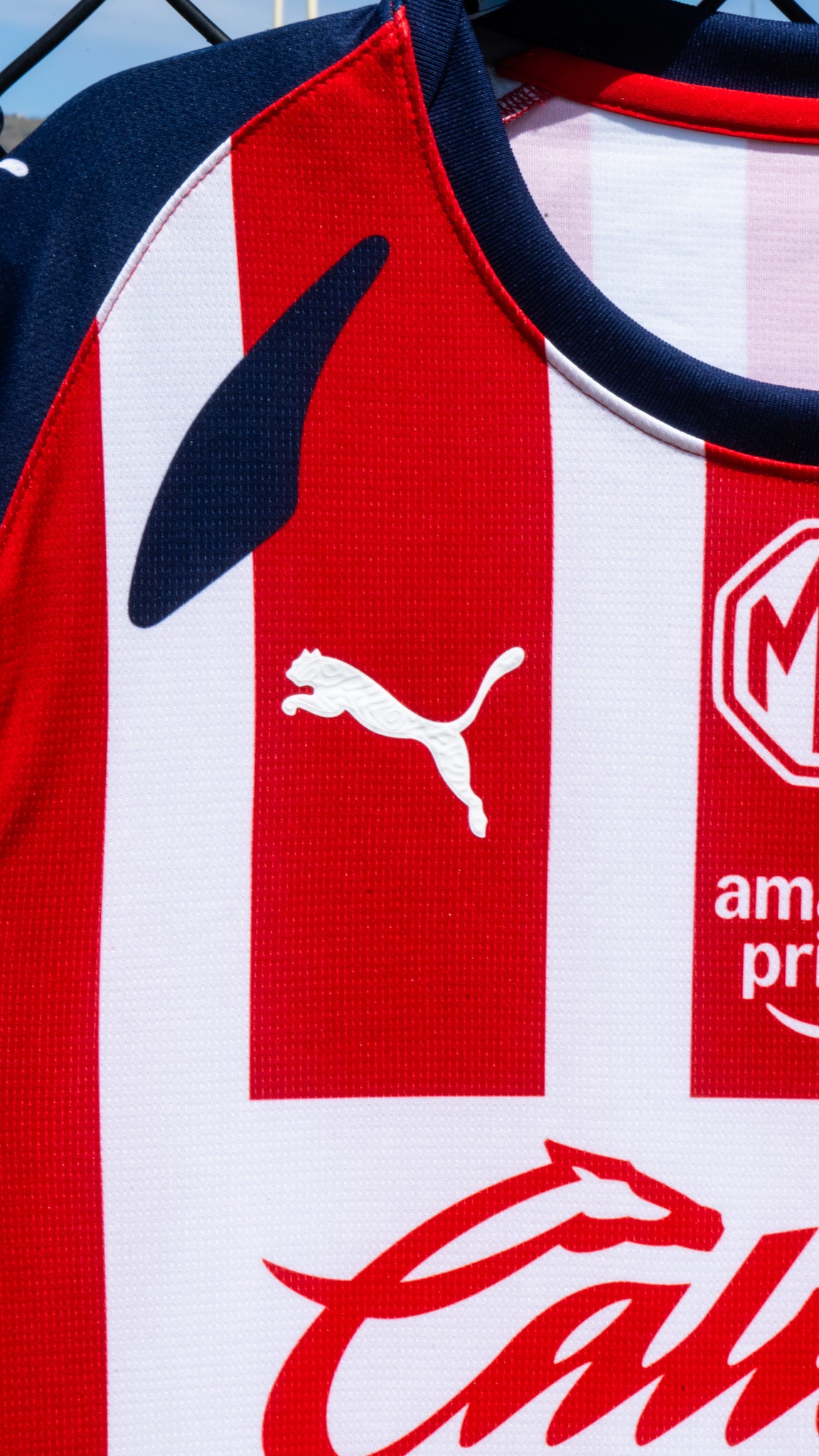 Close-up of a sports jersey with Puma logo and other brand markings.